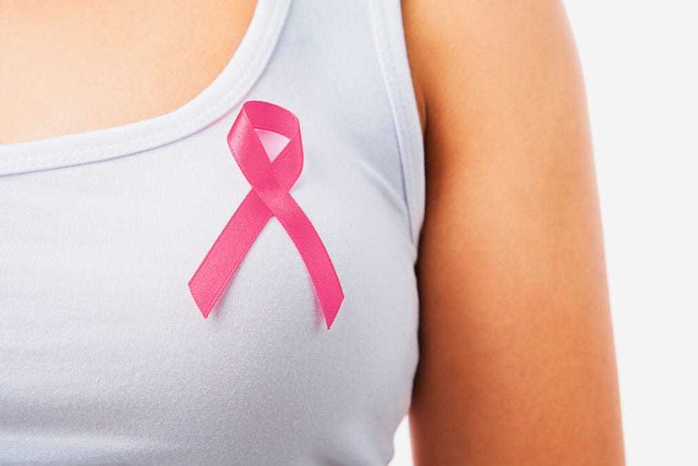 woman wearing breast cancer awareness ribbon