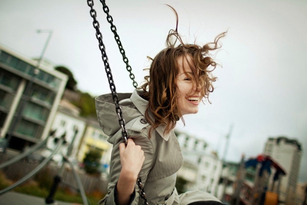 Happy woman on swing