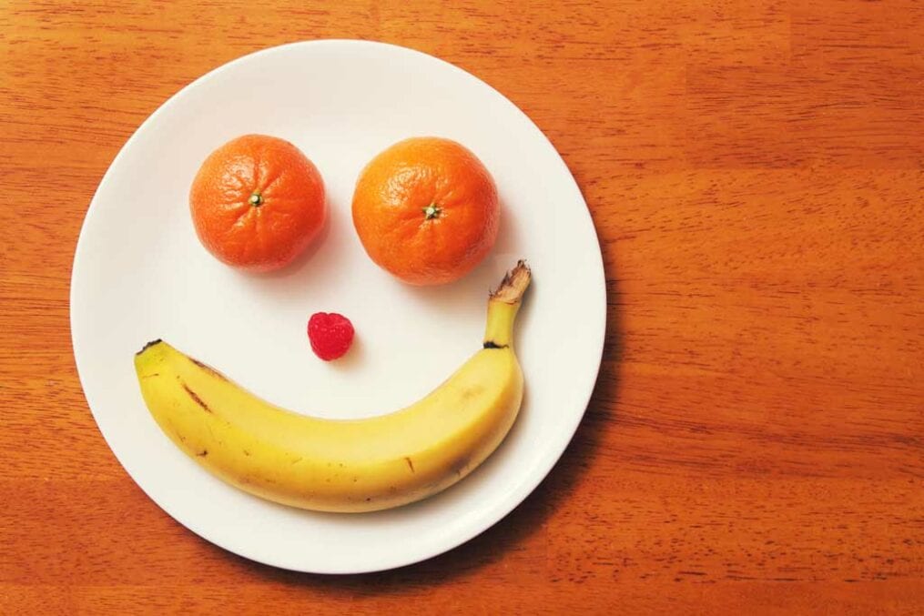 banana, oranges and a cherry on a plate