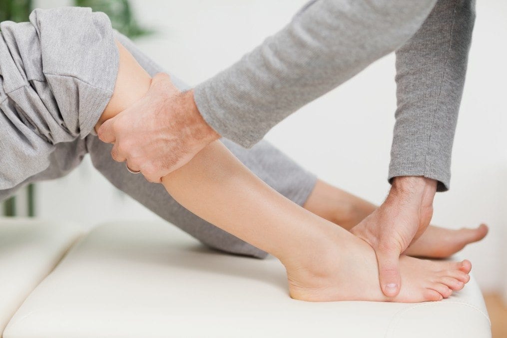 Woman receiving physiotherapy on her leg