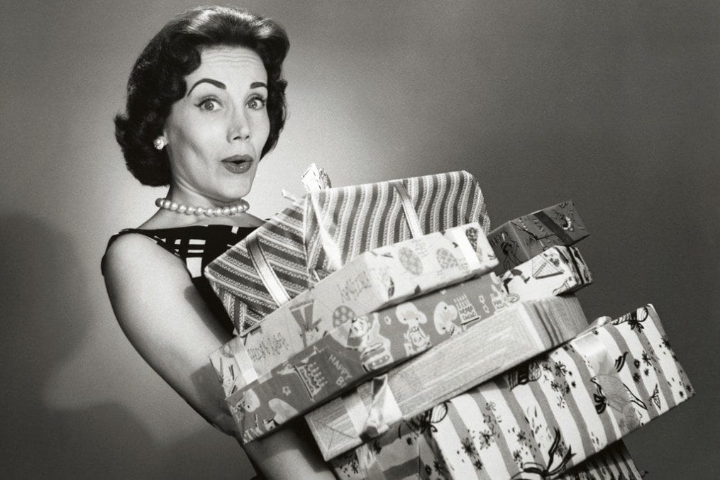 Woman carrying lots of christmas presents